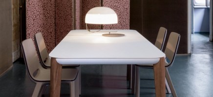 The Match table with white glass top and natural wood legs.